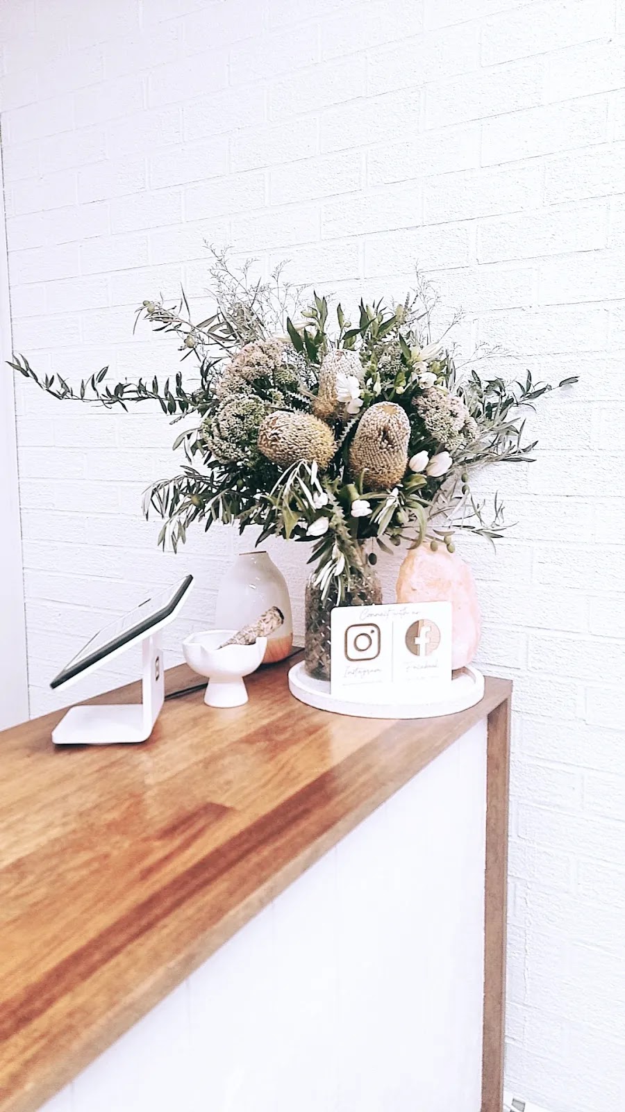 Banksia and eucalyptus flowers on the timber front counter