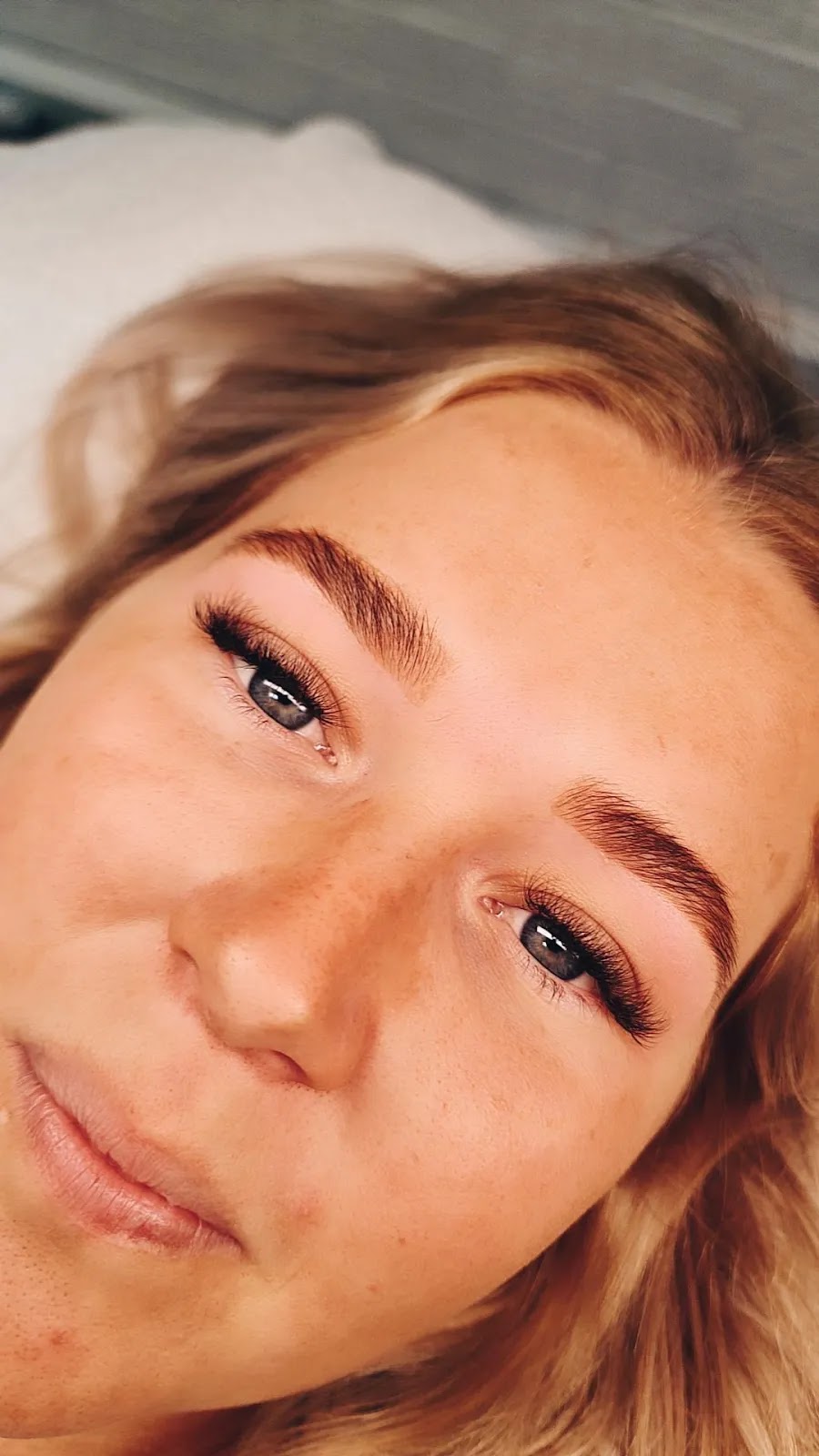 A client’s finished lash lift and shaped brows
