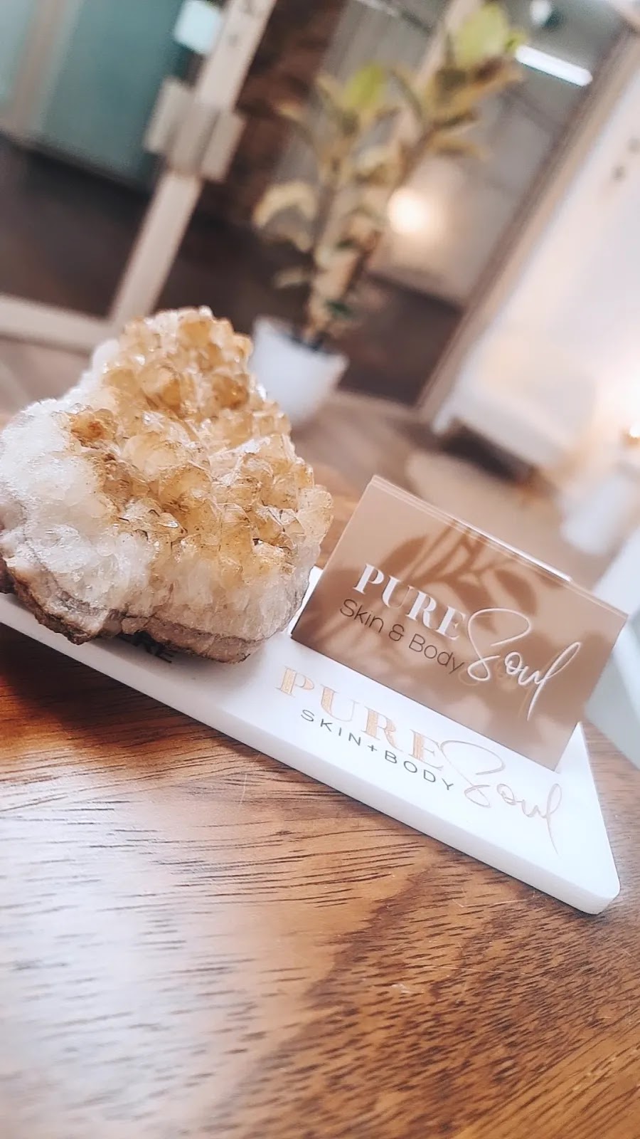 A citrine crystal beside the Pure Soul business card