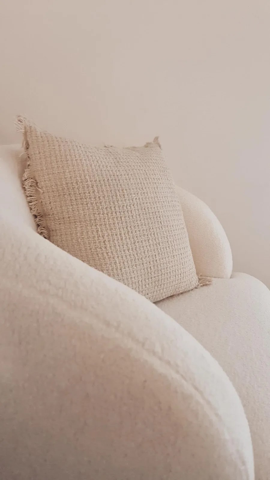 A boucle chair and linen cushion
